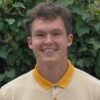 Headshot of Jacob in a yellow polo shirt