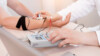 Stock image showing a patient's hands connected to a medical scanner